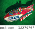 retro rocket tin toy close up on green felt 38279767