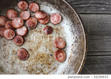 Fried sausages in a frying pan Fried sausages in a frying pan 38280635