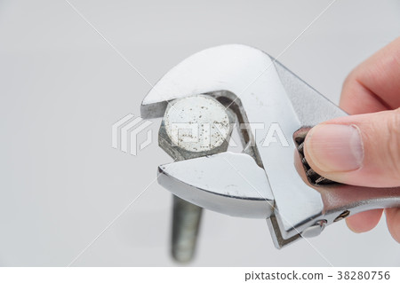 Scene turning a bolt with a monkey wrench 38280756