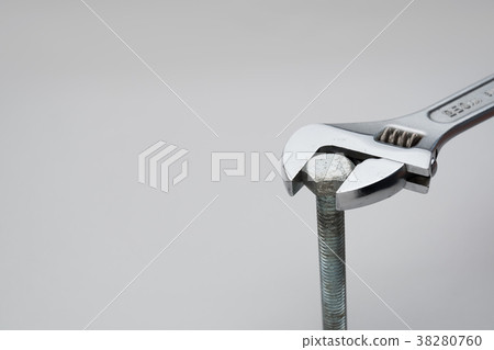 Scene turning a bolt with a monkey wrench 38280760