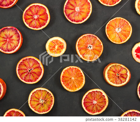 Red oranges on black background. 38281142