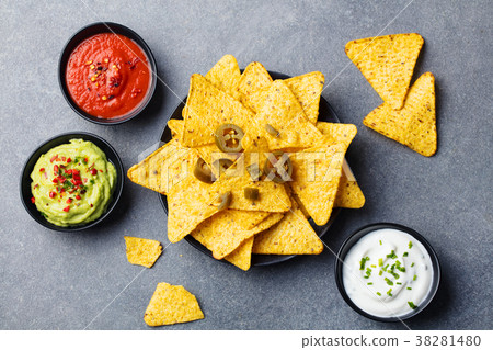 Nachos chips with dip variety. Grey background Nachos chips with dip variety. Grey background 38281480