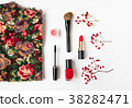 Woman cosmetics and top decorated. Flat lay in red 38282471