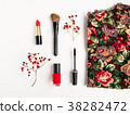 Woman cosmetics and top decorated. Flat lay in red 38282472