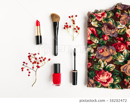 Woman cosmetics and top decorated. Flat lay in red Woman cosmetics and top decorated. Flat lay in red 38282472