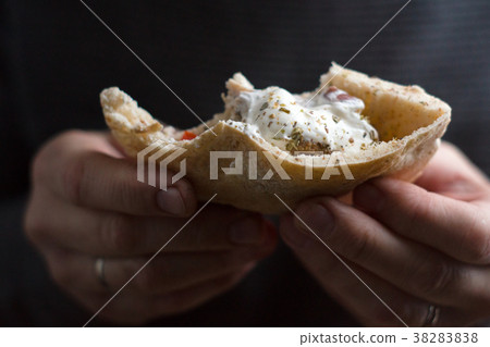 Man is holding a bite of a fajita close-up Man is holding a bite of a fajita close-up 38283838