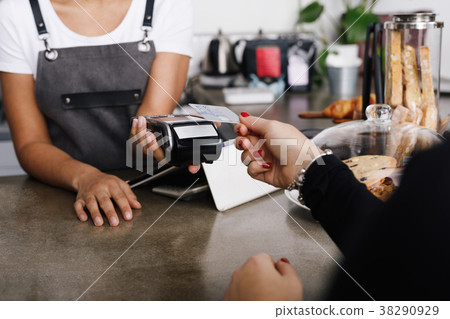 Customer making wireless payment using credit card Customer making wireless payment using credit card 38290929