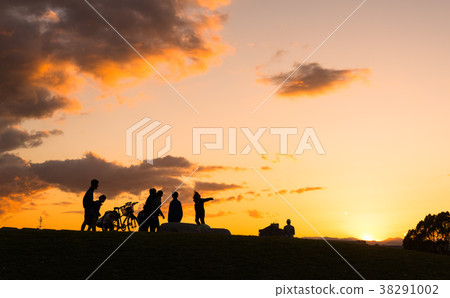 Silhouette of a person floating in the sunset 38291002