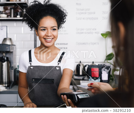 Customer paying with her credit card Customer paying with her credit card 38291210