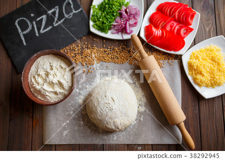 Pizza dough with ingredients on wood 38292945