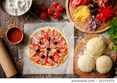 Pizza dough with ingredients on wood 38293019