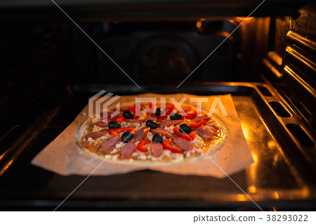 Fresh pizza on a metal baking tray 38293022