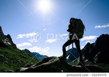 silhouette of woman hiking on sunrise mountain top 38293470