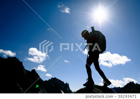 silhouette of woman hiking on sunrise mountain top 38293471