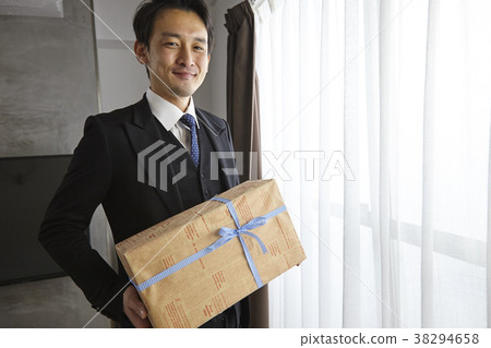 Stylish businessman giving a present 38294658