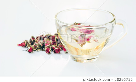 A cup of tea pink rose on a white background. 38295735