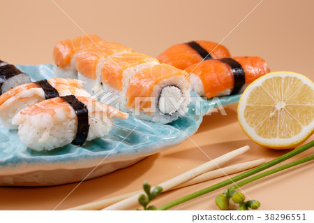 rolls and sushi on a plate in the form of fish 38296551