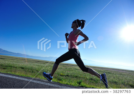 Young fitness sporty woman running on country road Young fitness sporty woman running on country road 38297763