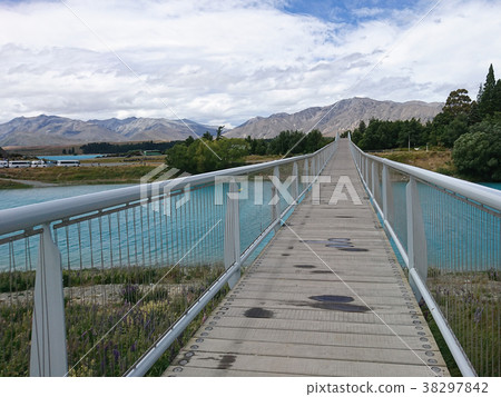 Wooden walkway over blue river Wooden walkway over blue river 38297842