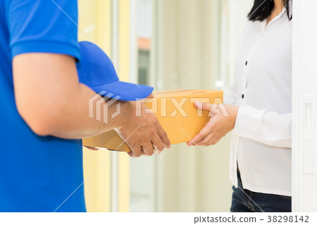 Woman receiving package from delivery man. Woman receiving package from delivery man. 38298142