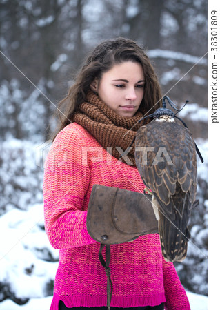Woman holding a falcon Woman holding a falcon 38301809