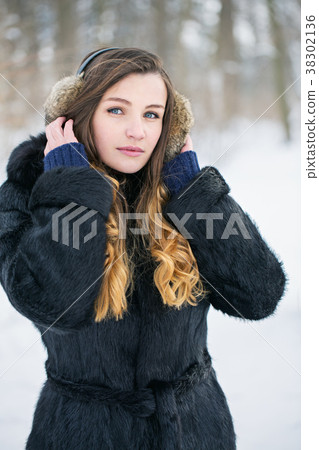 Beautiful woman in fur headphones Beautiful woman in fur headphones 38302136