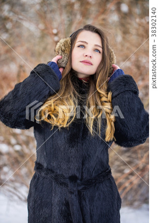 Woman in fur headphones Woman in fur headphones 38302140