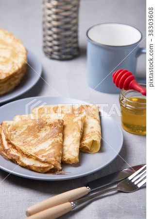 Traditional Russian pancakes with honey. 38303608