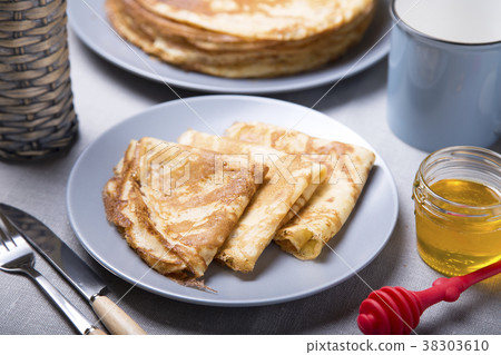 Traditional Russian pancakes with honey. Traditional Russian pancakes with honey. 38303610