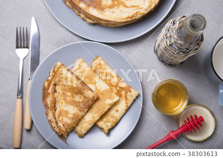 Traditional Russian pancakes with honey. Traditional Russian pancakes with honey. 38303613