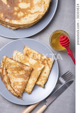 Traditional Russian pancakes with honey. Traditional Russian pancakes with honey. 38303614