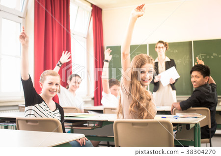 Math teacher standing in front of students who are 38304270