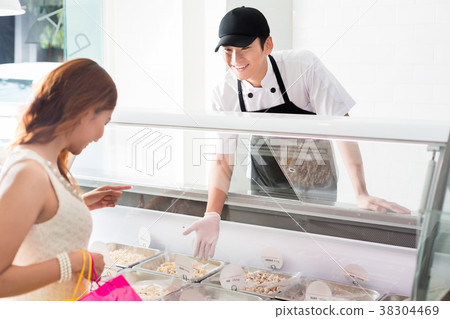 Young deli assistant serving a customer 38304469