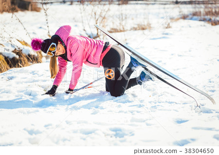Woman falling while doing cross country skiing 38304650