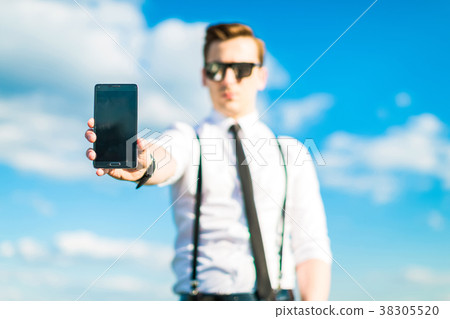 Young busunessman in white shirt, tie, braces and 38305520