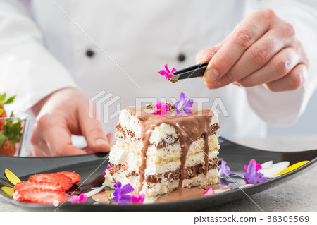 The chef prepares a dessert. The chef prepares a dessert. 38305569
