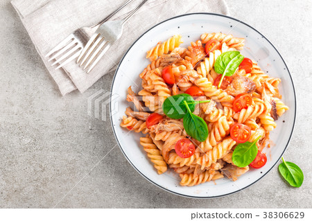 Pasta spirali stirred with fried pieces of chicken Pasta spirali stirred with fried pieces of chicken 38306629