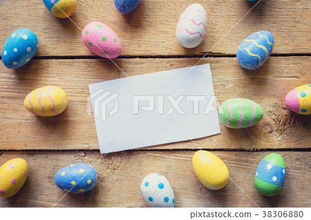 Colorful easter egg and paper card on wood 38306880