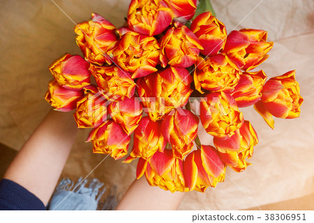 Fresh, red and yellow bouquet of flowers in a Fresh, red and yellow bouquet of flowers in a 38306951