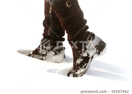 Brown women's shoes covered by snow in the winter Brown women's shoes covered by snow in the winter 38307462