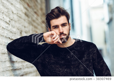 Young bearded man, model of fashion, in urban background wearing 38307469