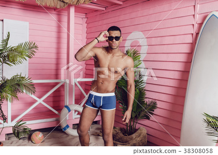 Sexy african american man in shorts standing on 38308058