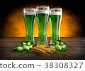 three glasses of green beer with barley and hops 38308327