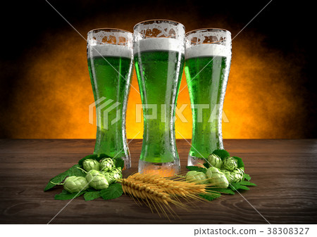 three glasses of green beer with barley and hops 38308327