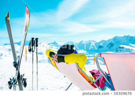 Picture from back of woman in armchair, skis Picture from back of woman in armchair, skis 38309676