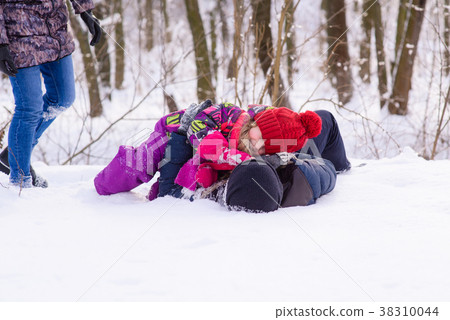 Happy family playing with snow in park Happy family playing with snow in park 38310044