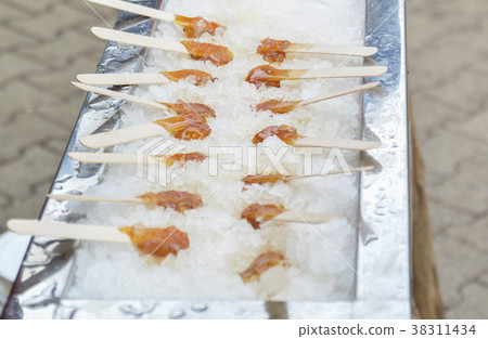 Hot maple syrup on a stick in the snow Hot maple syrup on a stick in the snow 38311434
