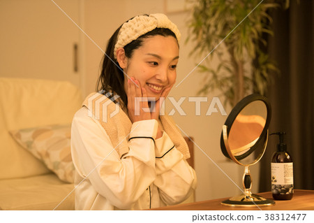 Young Japanese woman doing skin care at night 38312477