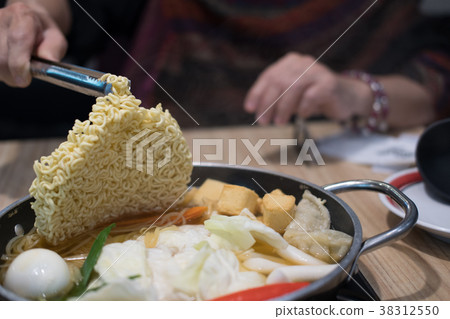 tokpokki traditional korean food. noodle, egg, vegetable and meat in hot pot in restaurant tokpokki traditional korean food. noodle, egg, vegetable and meat in hot pot in restaurant 38312550