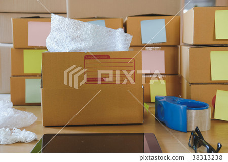 tablet, packing accessories at workplace of startup small business owner. cardboard parcel box for online selling. entrepreneur, SME seller desk. e-commerce, shipping concept 38313238